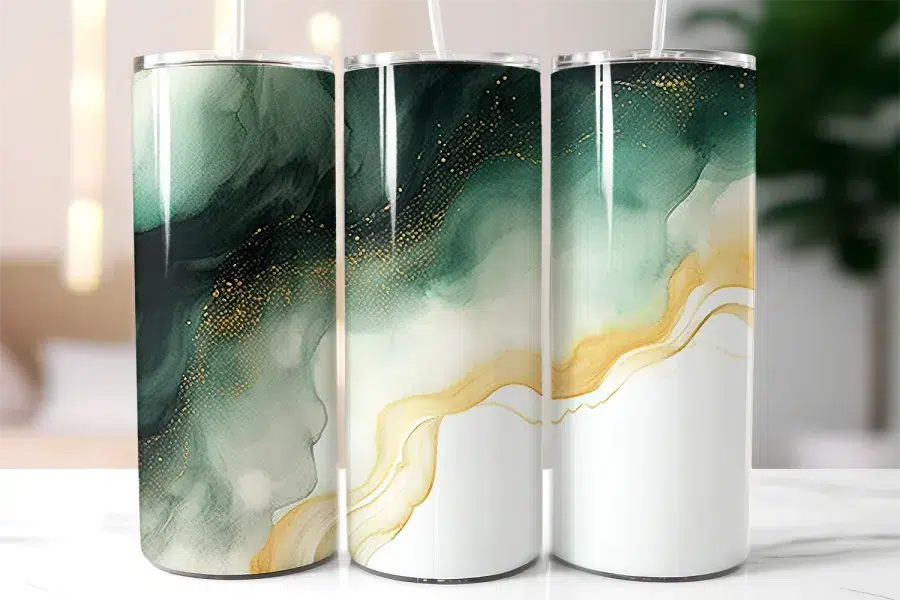 Three Tall Tumblers With Straws; Each Features An Abstract Design Of Green And Gold Watercolor-Style Swirls On A White Background.
