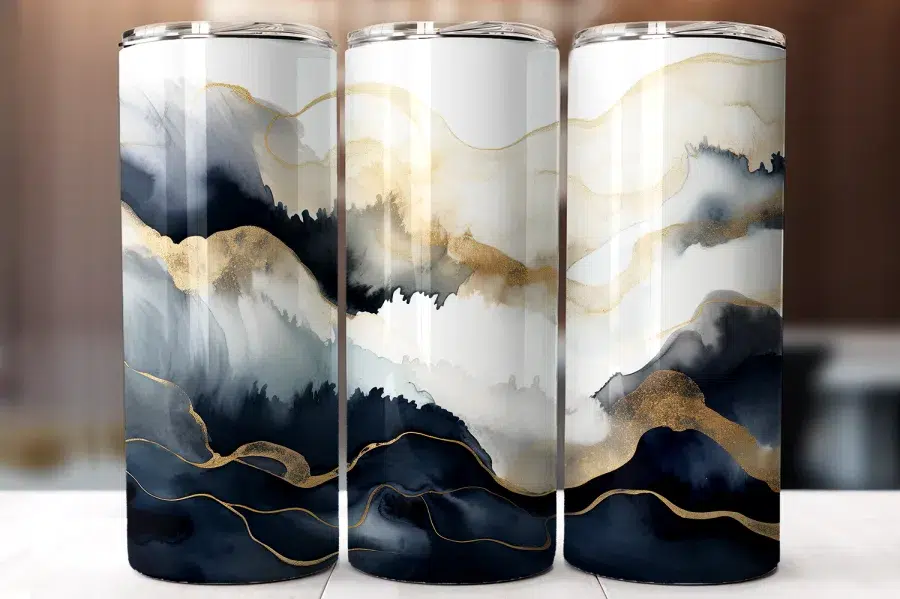 Three Tumblers With An Abstract Design Of Navy Blue, Gray, And Gold Watercolor-Style Waves.