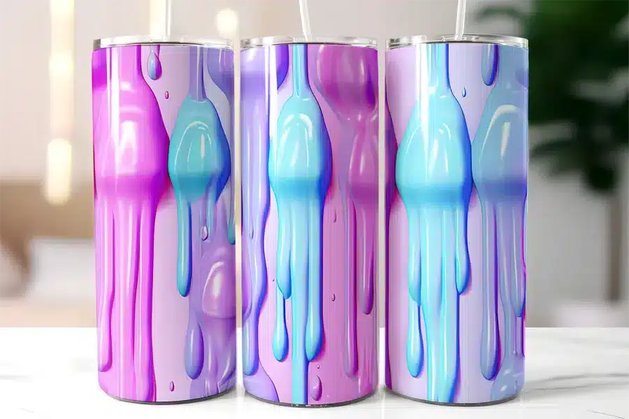 Three Pastel-Colored Tumblers With Dripping Paint Designs.