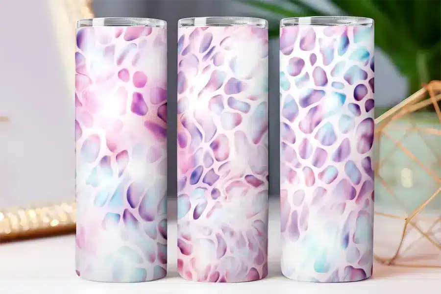 Three tall tumblers with a pastel purple and blue abstract pattern.