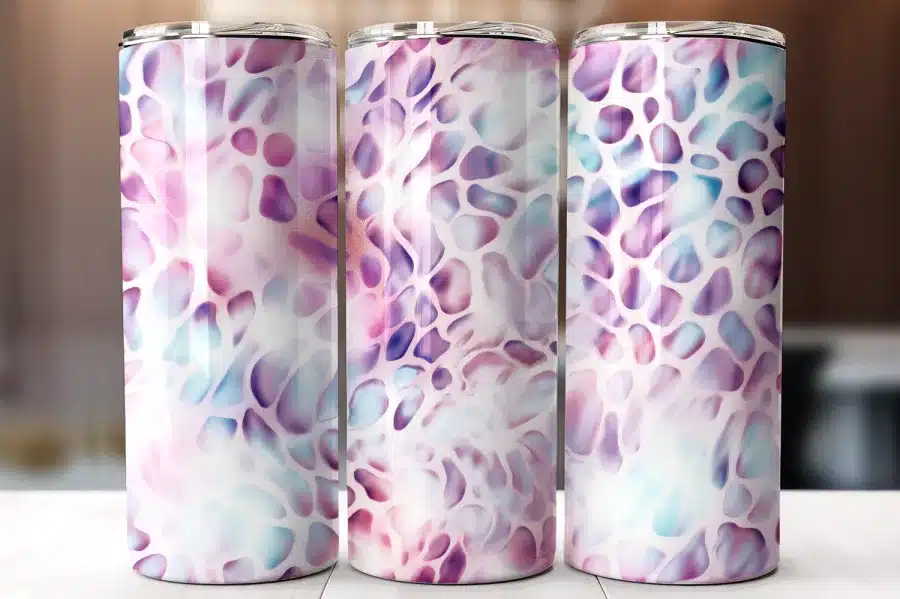 Three Pastel Purple And Blue Patterned Tumblers.