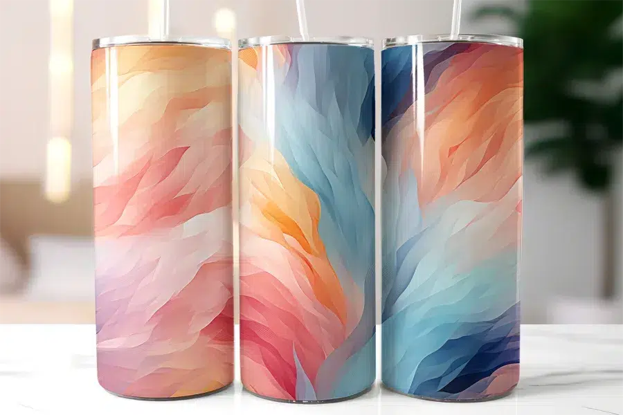Three Stainless Steel Tumblers With Abstract Wavy Pastel Designs.