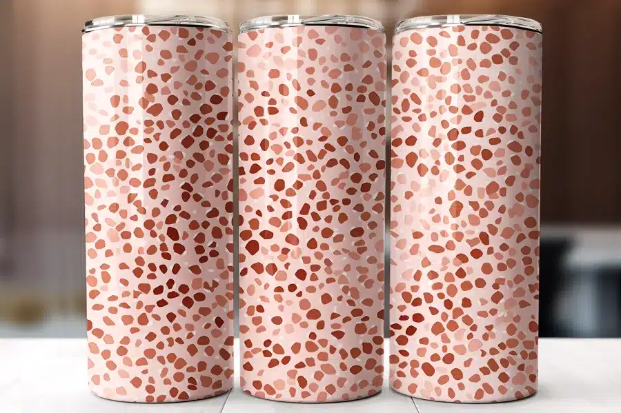 Three Pink And Terracotta Patterned Tumblers.