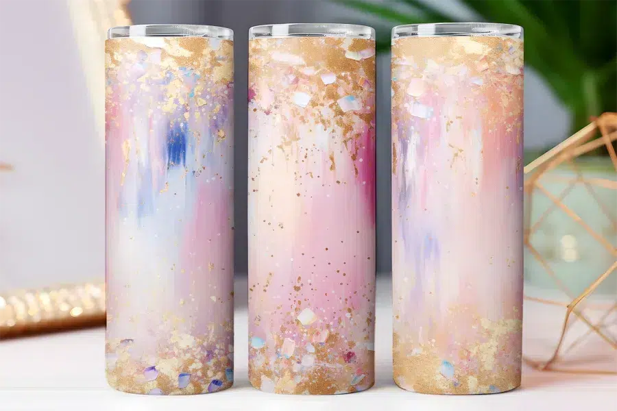 Three tall tumblers with an abstract pink, white, and gold design.