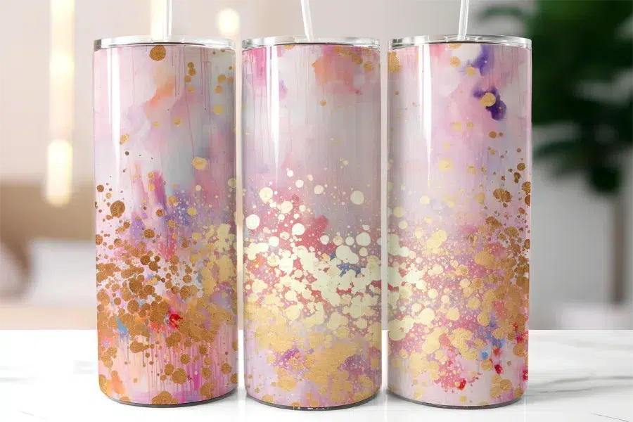 Three Pastel Pink And Gold Tumblers With Abstract Designs.