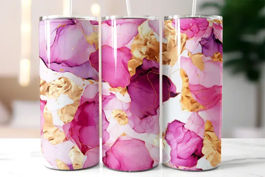 Three Stainless Steel Tumblers With Pink And Gold Abstract Designs.