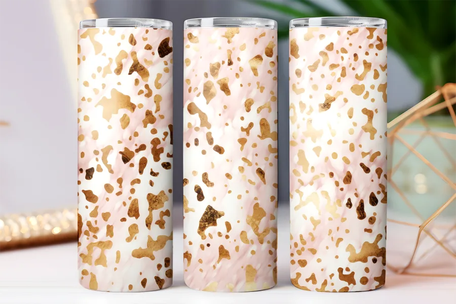 Three tumblers with a pink and gold abstract pattern.