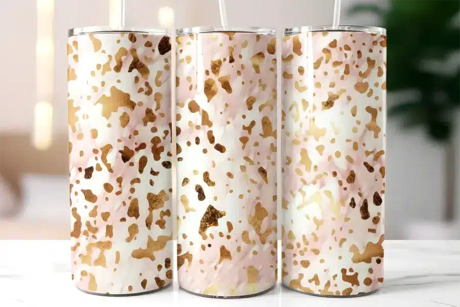 Three Stainless Steel Tumblers With Straws, Featuring A Pink And Gold Abstract Pattern.