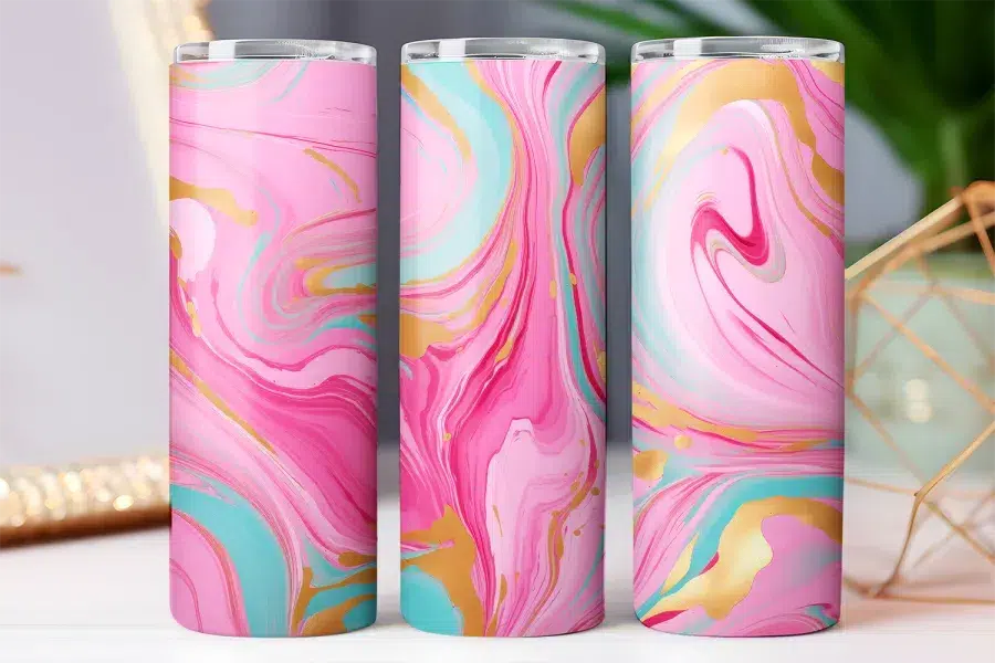 Three pink, teal, and gold marble-patterned tumblers.