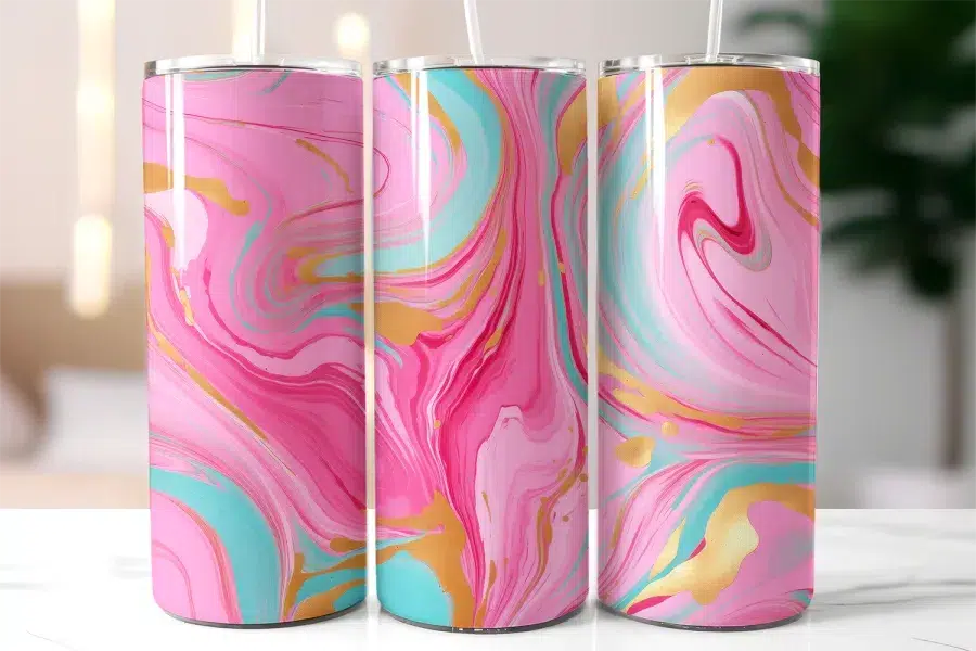 Three Pink, Teal, And Gold Marble-Patterned Tumblers With Straws.
