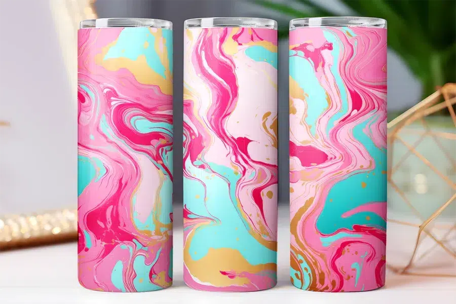Three pink, teal, and gold marble-patterned tumblers.