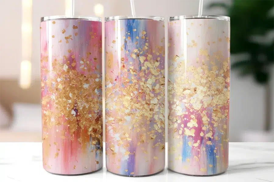 Three Tall Tumblers With Abstract Pink, Gold, And Blue Designs.