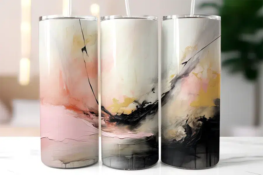 Three Tall Tumblers With Abstract Art Designs In Shades Of Pink, Gold, And Black.