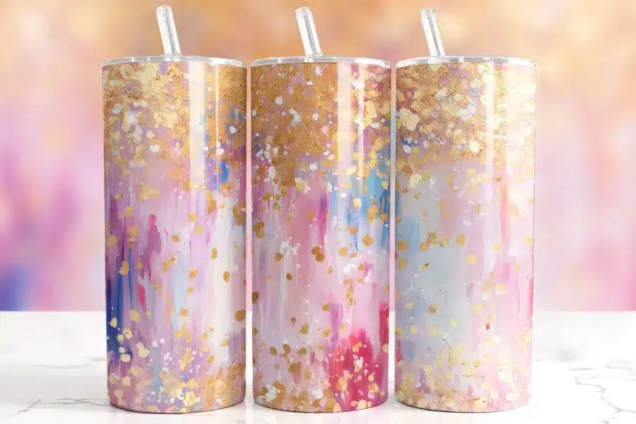 Pink Gold Glitter Tumbler Wrap Design Featuring Soft Pink, Blue, And Coral Brushstrokes With Scattered Metallic Gold Foil And White Splatter Accents