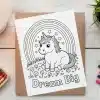 Coloring Page Featuring A Cute Unicorn Sitting Under A Rainbow With The Words Dream Big.