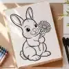 Line Drawing Of A Rabbit Holding A Flower.