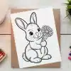 Line Drawing Of A Rabbit Holding A Flower.