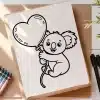 Koala Holding Heart-Shaped Balloon Coloring Page.