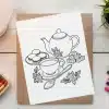 A Drawing Of Teapot And Teacups And Cookies On A Brown Card