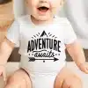 Baby Wearing A White Onesie With The Text Adventure Awaits And A Mountain Graphic.