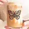 A Glass Iced Coffee With A Butterfly Design.