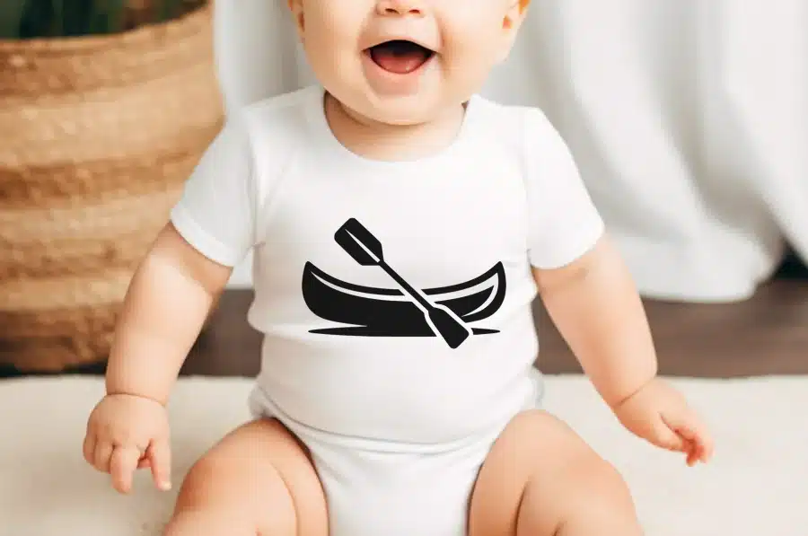 Baby Wearing A White Onesie With A Black Canoe And Paddle Graphic.