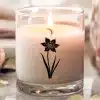 A Candle With A Flower Design On It
