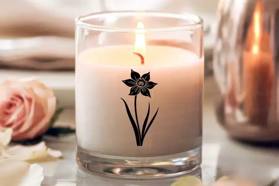 a candle with a flower design on it