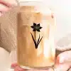 A Person Holding A Glass Of Liquid