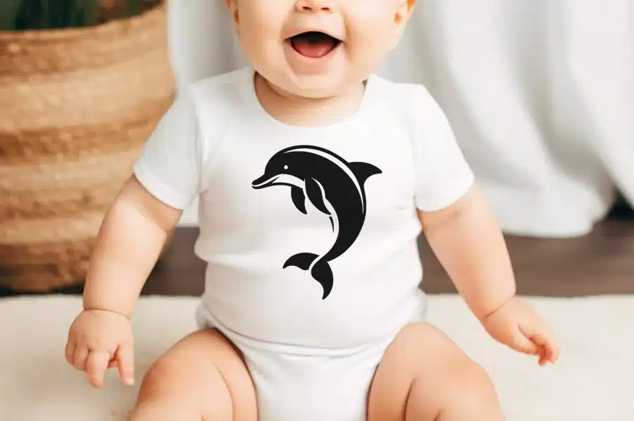 Baby Wearing A White Bodysuit With A Black Dolphin Graphic.