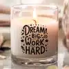 Lit Candle In A Glass Jar With The Text Dream Big Work Hard.