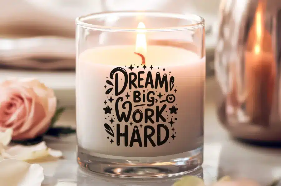 Lit Candle In A Glass Jar With The Text Dream Big Work Hard.