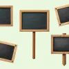 Five Blank Chalkboard Signs With Light Brown Wooden Frames.  One Sign Is On A Post.