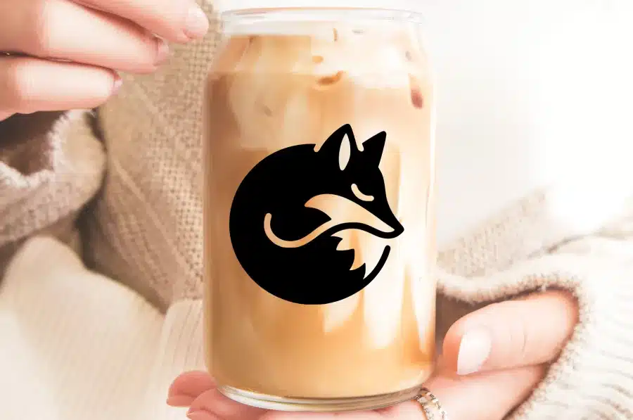 A Glass Of Iced Coffee With A Curled-Up Fox Logo.