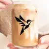 A Person'S Hands Holding A Glass Jar Of Iced Coffee Featuring A Geometric Hummingbird Logo.