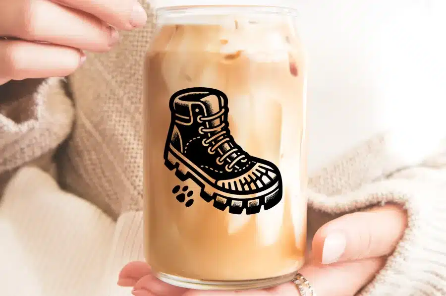 A Glass Of Iced Coffee With A Graphic Of A Hiking Boot On It.