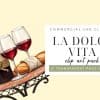 A Bottle Of Red Wine, Two Glasses Of Red Wine, A Baguette, And Olives On A Small Table.