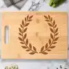 Bamboo Cutting Board With Engraved Laurel Wreath Design.