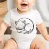 Baby Wearing A White Onesie With A Line Drawing Of A Sleeping Cat.