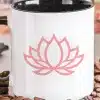 White Coffee Mug With Black Handle, Featuring A Pink Lotus Flower Design.
