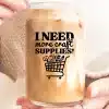 A Person Holding A Glass Of Liquid