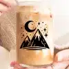 A Glass Of Iced Coffee With A Mountain And Moon Design.