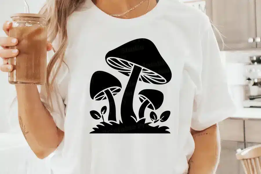 A Woman Wearing A White Shirt With A Black Mushroom Design On It