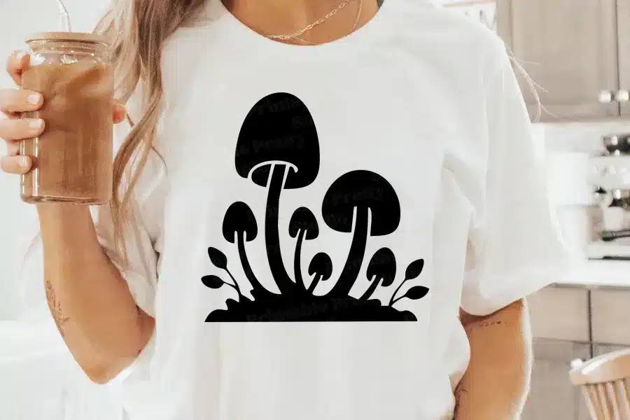 A Person Wearing A White Shirt With Black Mushrooms On It
