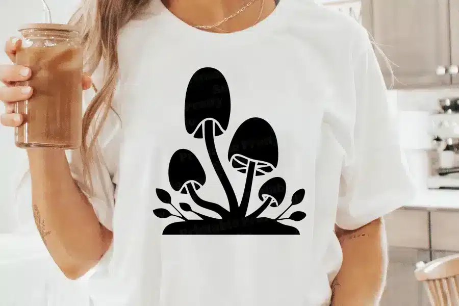 A Person Wearing A White Shirt With Black Mushrooms On It