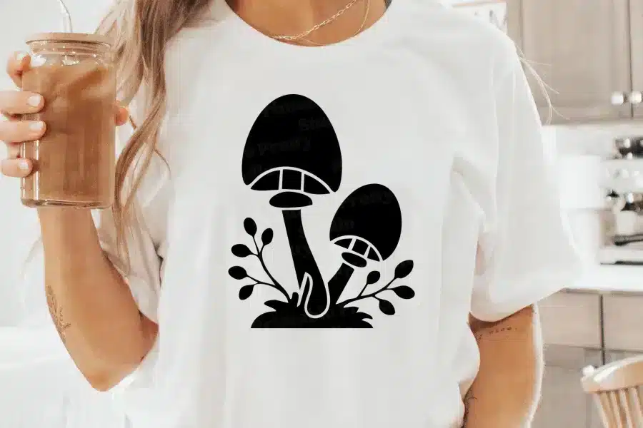 A Person Wearing A White Shirt With A Black Mushroom On It
