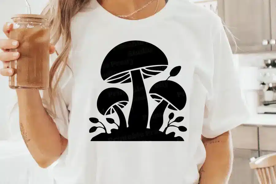 A Woman Wearing A White Shirt With A Black Mushroom Design