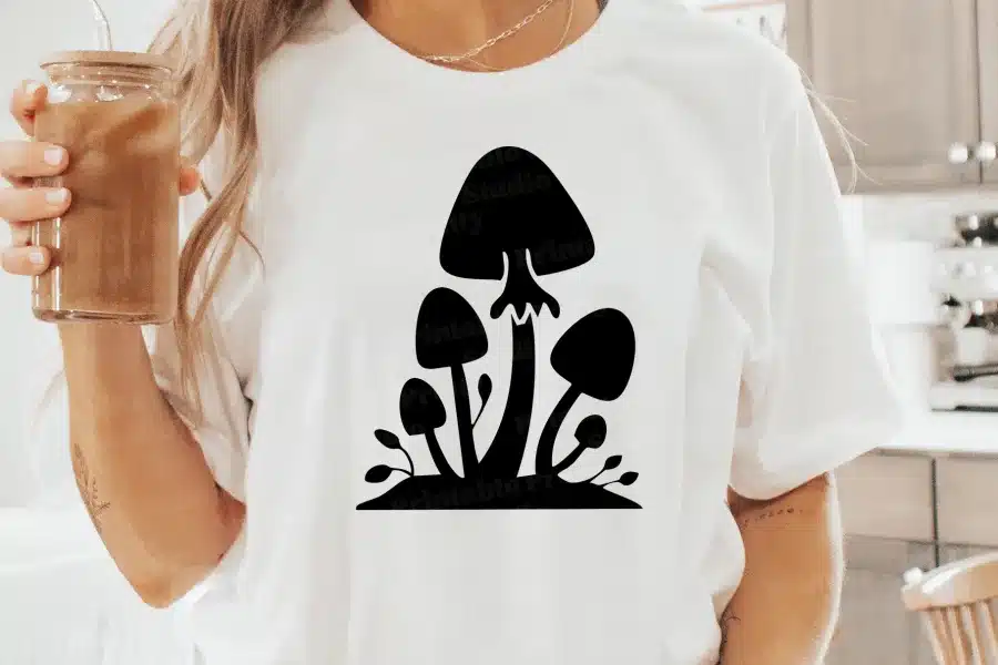 A Person Wearing A White Shirt With A Black Mushroom On It