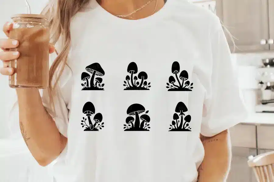 A Woman Wearing A White Shirt With Black Mushrooms On It