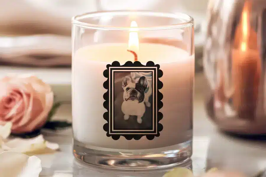 a candle with a picture of a dog